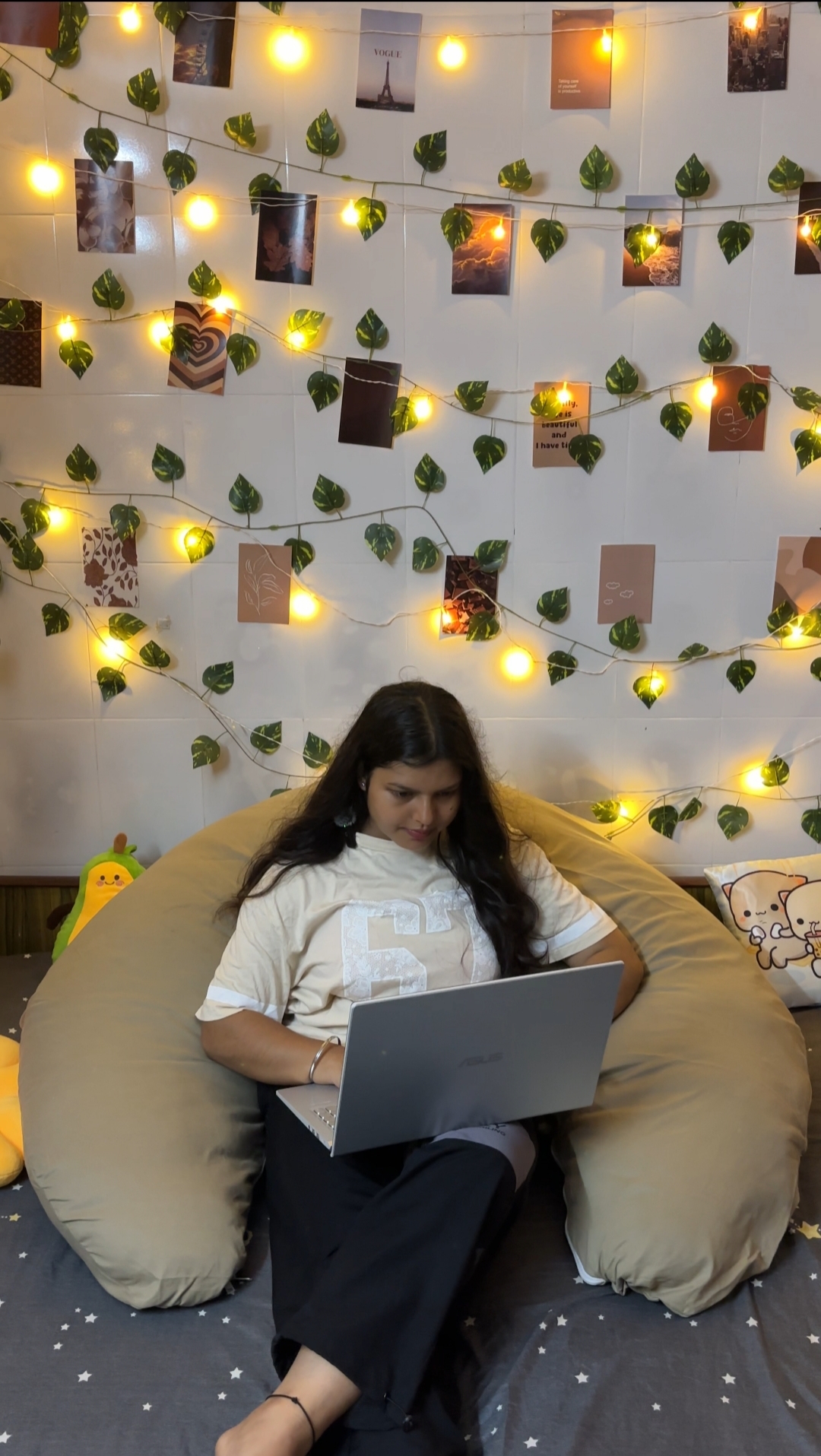 Woman using the Diwan Body Pillow with a laptop in bed